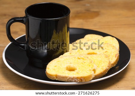 Black coffee cup Garlic bread on Wooden Table