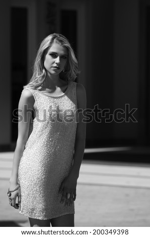 Black and white portrait of gorgeous blonde woman in urban setting