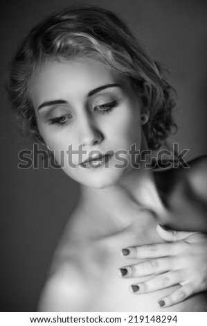 Portrait in black and white of beautiful young woman looking down