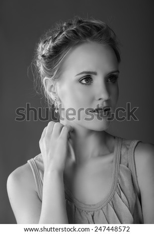 Monochrome black and white portrait of beautiful blonde woman looking to the side