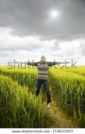 Man on a field. Man on a wheat field looking for a peace moment. Reaching relax and peace