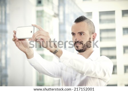 Selfie of a young hipster man outdoors. Modern man making photos to himself