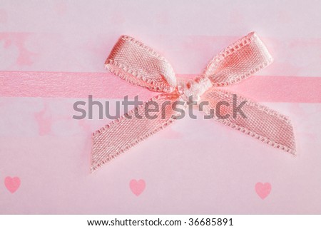 pink bow on background with hearts