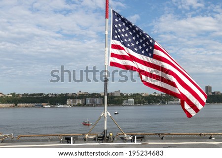 The Stars and Stripes flies on the deck of a US Navy battleship