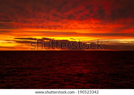 Blood-red sunset with clouds over the Atlantic Ocean at the Equator before the storm.
