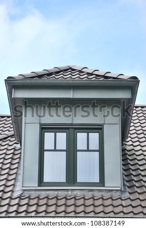 Architectural detail of small dormer window on a roofing tile