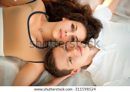 A pair of lovers. The love story of two young people. Man and woman lying together. Feelings of love between two people. Love story.