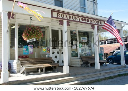Roxbury, Vermont, USA - September 20, 2013: Several cars are parked outside the busy Roxbury Store on Main Street of this small Vermont town on a bright autumn day.