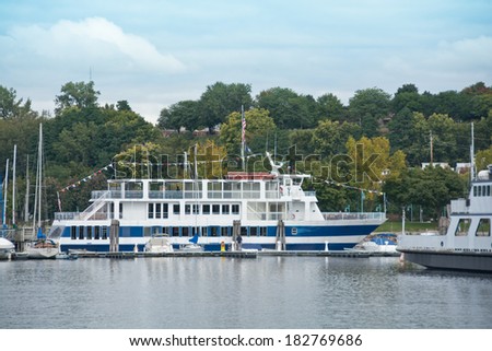 Burlington, Vermont, USA - September 27, 2013: Tourists sit on the deck of the popular sightseeing ship, the Spirit of Ethan Allen III on an autumn afternoon.