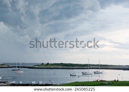 Rye, NH, USA - August 7, 2014: Sailboats fill Gosport Harbor as a summer storm passes overhead.