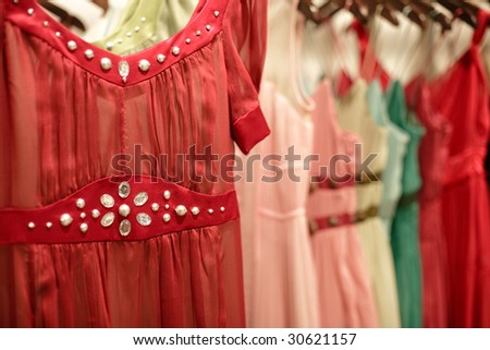 row of stylish dresses on racks