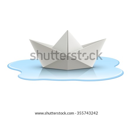 Paper boat in puddle