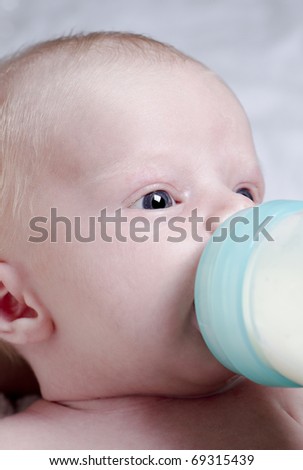 Close up photography of a newborn baby with bottle