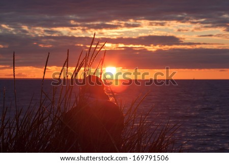 woman alone watching the sea sunset