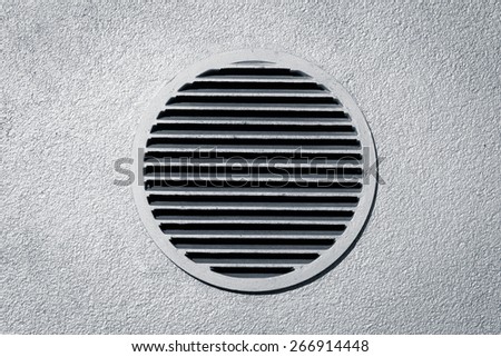 Circle vent window on metallic concrete wall