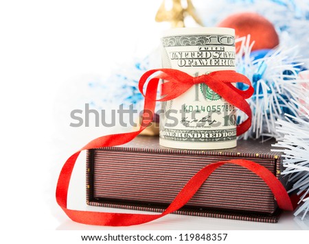 Money, gift box and Christmas decorations on white background.