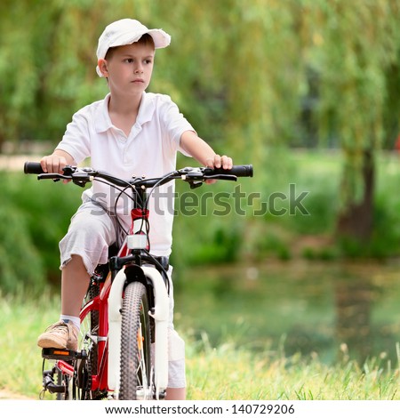Child on a bike in the town park