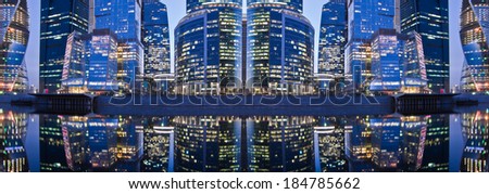 Panoramic evening city view with its reflection in the water of the river.