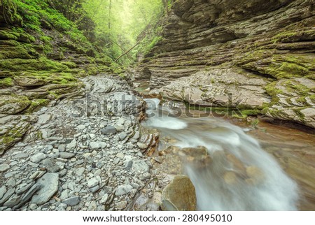 Creek with pure water in the deep canyon.