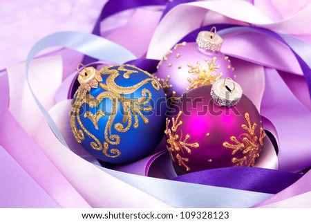 Christmas decorations on purple ribbons.
