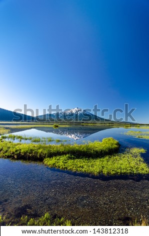 Vertical shot of Mount Bachelor being reflected in Sparks Lake near Bend, Oregon