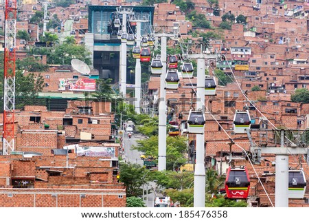 MEDELLIN, COLOMBIA - MARCH 8: Metrocable cars arriving at a station in Medellin, Colombia on March 8, 2014.  Metrocable is the first gondola lift system in the world dedicated to public transportation