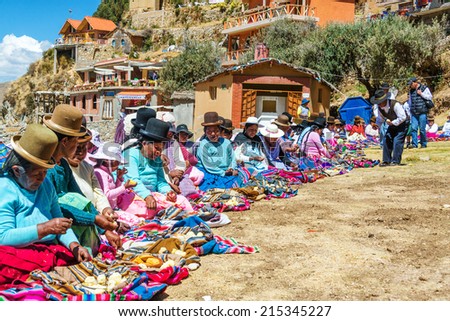 ISLAND OF THE SUN, BOLIVIA - AUGUST 20: Indigenous Aymara women on Island of the Sun, Bolivia offering food to anyone who wants it on August 20, 2014