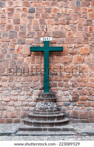 Green cross in front of the cathedral in Cusco, Peru