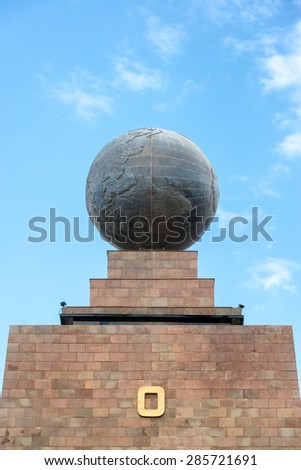 Large metal globe on the top of the monument to the equator in Quito, Ecuador
