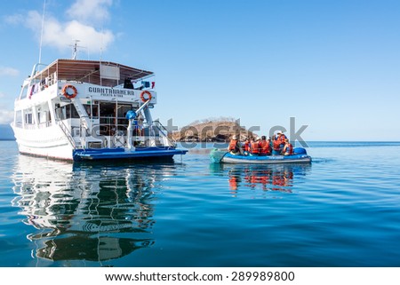 GALAPAGOS ISLANDS, ECUADOR - JANUARY 15: Tourists on a dinghy returning to a cruise ship in the Galapagos Islands, Ecuador on January 15, 2015