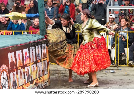 EL ALTO, BOLIVIA - AUGUST 10:  Two indigenous women fighting at a wrestling match in El Alto, Bolivia on August 10, 2014