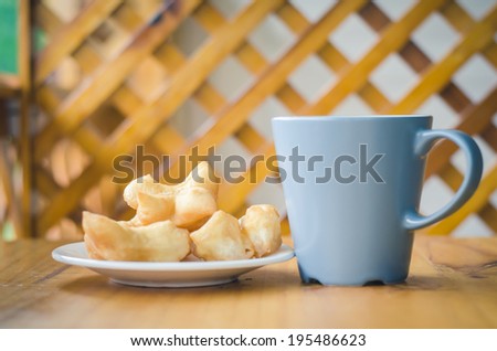 Coffee with fried bread stick, Thai style food.