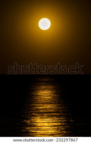 Reflection of the moon on the sea surface. Moonlight path.