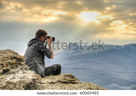 Similar – Man photographing landscape from observation deck