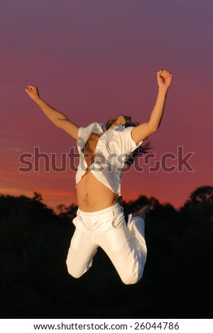Man jumping for joy - sunset background