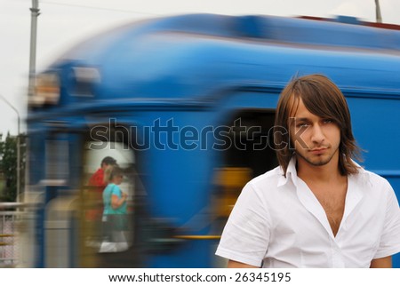 Man in a metro station with blured by motion train on the background