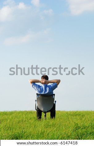 A manager sitting on a chair in nature