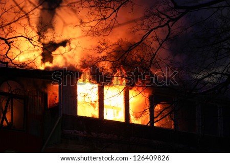 residential home on fire, fully involved, engulfed in orange fire and flames
