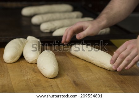 In bread bakery, food factory, manual workshop, people working together making handmade bread