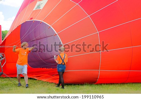 BONN, GERMANY 15TH JUNE 2014 - Unidentified persons blowing up a hot air balloon in the Rheinaue  - a 40 acre leisure park along the banks of the River Rhine