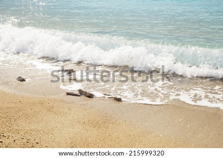 Image of gentle waves on a sea front with rocks in the foreground, the image was taken in Olu Deniz, a popular european holiday destination