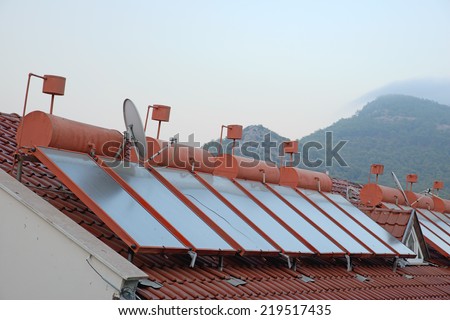 Image showing solar panels and water storage on rooftops of houses in turkey