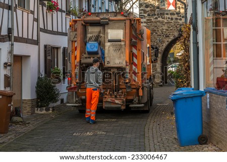 ERPEL, GERMANY 24 NOVEMBER, 2014 - Unidentified person emptying the bins, the job is carried out every monday in this peaceful village