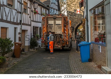 ERPEL, GERMANY 24 NOVEMBER, 2014 - Unidentified person emptying the bins, the job is carried out every monday in this peaceful village