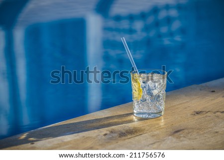 Classic Old Fashioned cocktail near waterpool on the wood