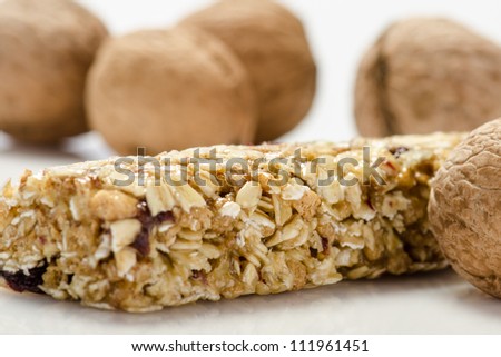 Fitness bar  and nuts against white background