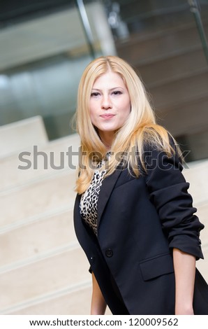Portrait of serious businesswoman on the top of he stairs