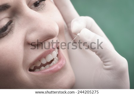 Young woman  with perfect teeth and dental instruments