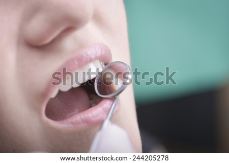 Young woman  with perfect teeth and dental instruments
