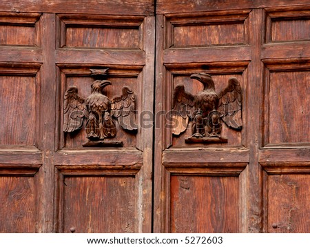 Two eagles carved in wood on an old door